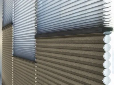 Close-up image of cellular shades in alternating light and dark colors, showcasing their texture and layered design.
